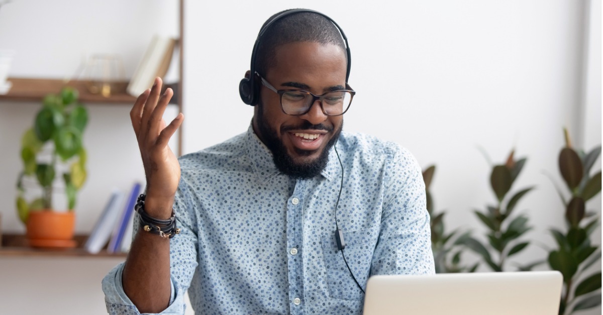 Photo of a contact center agent smiling while using a cloud-based contact center solution